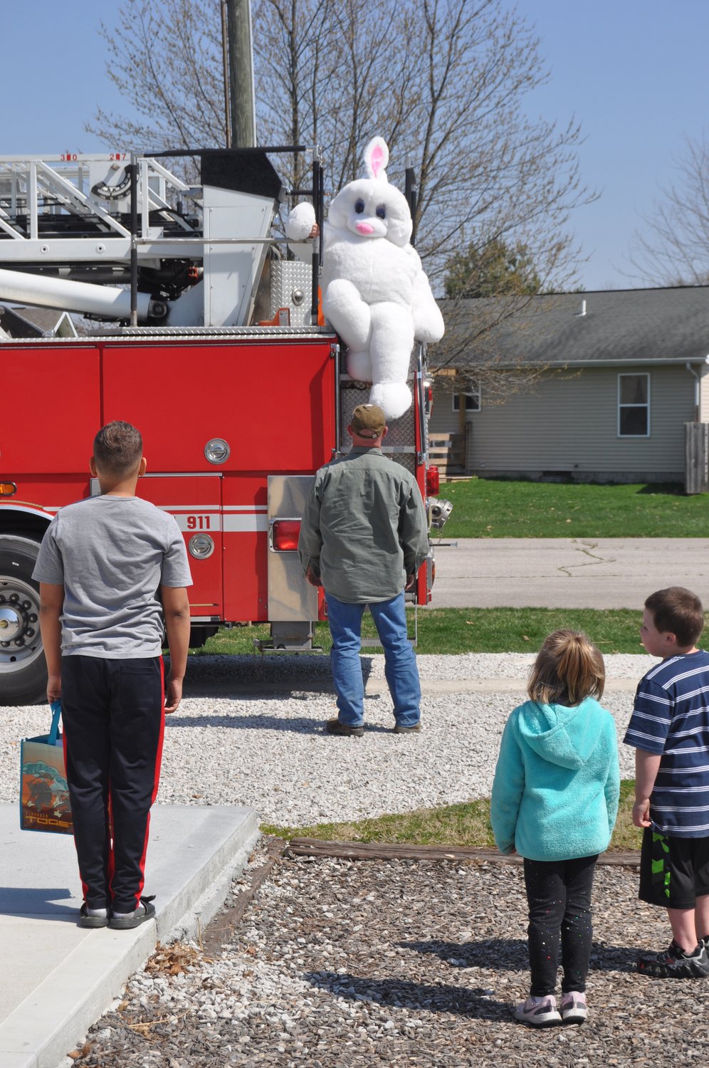 The Easter Bunny hops off a fire truck at the Easter egg hunt at Tremaine Park in Waynetown Saturday. The event was sponsored by the Waynetown Merchants Association.